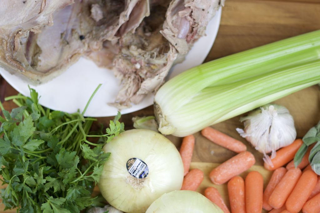 Ingredients for turkey stock on a cutting board shot from overhead.